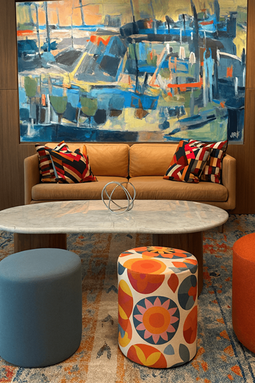 Washington apartment for rent - A living room with a couch, ottoman, and a painting on the wall.