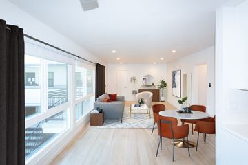West Hollywood apartment for rent - a living room with a large window and a table and chairs