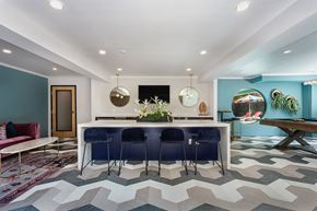 Los Angeles apartment for rent - a kitchen with a bar and blue chairs and a rug