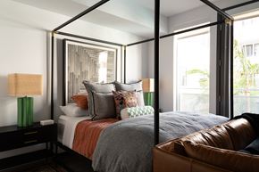 Los Angeles apartment for rent - a bedroom with a large bed and a leather couch