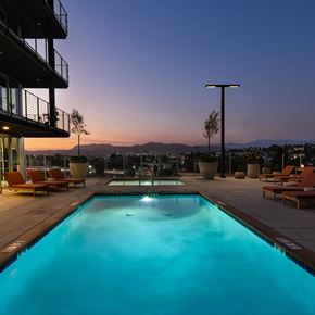 Los Angeles apartment for rent - A swimming pool with a view of the mountains at dusk.