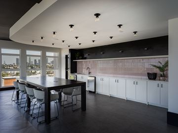 Los Angeles apartment for rent - A modern kitchen with a long table and chairs.
