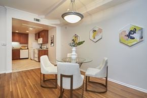 Los Angeles apartment for rent - Dining table just outside spacious kitchen with wooden cabinets and white walls