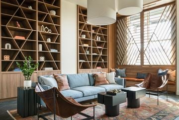Los Angeles apartment for rent - A living room with a blue couch and a wooden shelf.