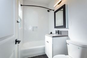 Los Angeles apartment for rent - Bathroom With White Cabinetry, Dual Shower and Tub and Modern Fixtures