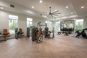Burbank townhouse for rent - a spacious fitness room with hardwood flooring and large windows
