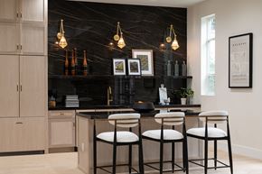 Burbank townhouse for rent - a black and white kitchen with brass pendant lights