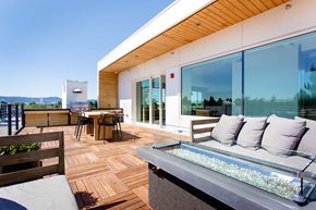 Portland apartment for rent - Rooftop outdoor patio with couches, tables, and a BBQ