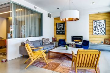 Portland apartment for rent - a living room with yellow chairs and a fireplace