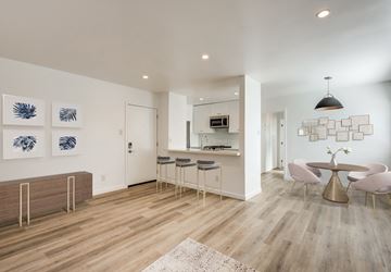 West Hollywood apartment for rent - a living room and kitchen with a table and chairs