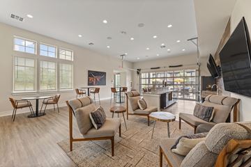 Grand Prairie apartment for rent - A living room with a large couch and a television.