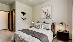 Grand Prairie apartment for rent - A bedroom with a large bed and a painting on the wall.