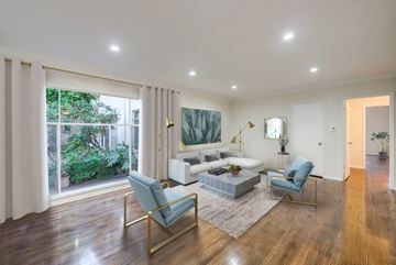 Los Angeles apartment for rent - a living room with a couch and chairs and a large window