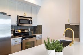 Dublin apartment for rent - A kitchen with a stove top oven and a microwave above it.