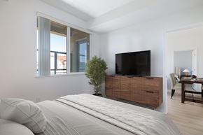Dublin apartment for rent - A bedroom with a large bed and a flat screen TV mounted on the wall.