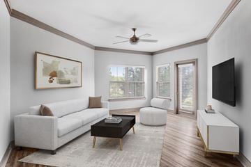 Overland Park apartment for rent - A living room with a white couch, a coffee table, and a painting on the wall.