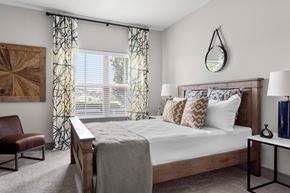 Overland Park apartment for rent - Bedroom with wooden furniture and patterned curtains at Adara Overland Park Apartments, Overland Park, Kansas