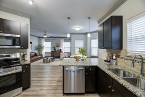 Overland Park apartment for rent - Open concept kitchen with island and pendant lighting at Adara Overland Park Apartments, Overland Park, KS