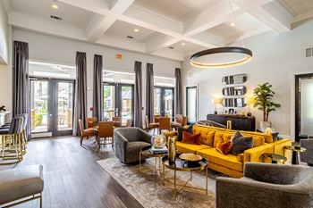 A modern living room with a yellow sofa and wooden floors.