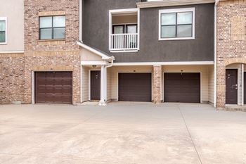 A two-story residential building with a garage on the first floor.