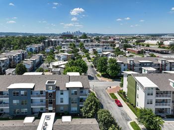 A view of a residential area with apartment buildings and a road.