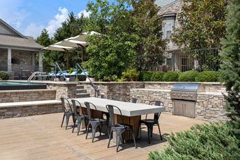 Outdoor kitchen with stone bar and builtin grill