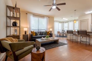 Sugar Land apartment for rent - A living room with a green chair and a brown coffee table.