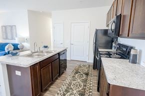 Pickerington apartment for rent - A kitchen with a black refrigerator and a white counter top. at Overland Park, Pickerington, 43147