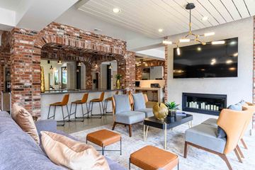 Carmel apartment for rent - A living room with a fireplace and a large painting on the wall.