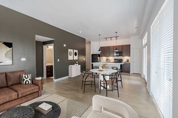 Indianapolis apartment for rent - A modern living room with a brown couch and a coffee table.