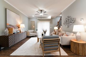 Shawnee apartment for rent - A modern living room with a wooden chair and a large painting on the wall.