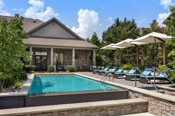 Outdoor pool with covered lounge area and cabanas