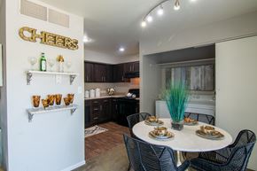 Roeland Park apartment for rent - A dining area with a white table and black chairs.