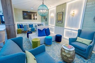 Hilliard apartment for rent - A living room with blue chairs and a white wall.