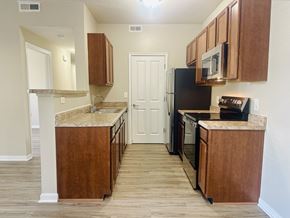 Hilliard apartment for rent - A kitchen with wooden cabinets and a stainless steel appliances at The Greyson, Hilliard, 43026