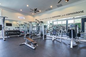 Overland Park apartment for rent - A gym with a variety of equipment and a sign that says at Sovereign at Overland Park Apartments, Overland Park, KS 66213