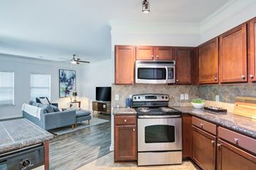 Overland Park apartment for rent - A kitchen with a stove top oven and microwave above it.