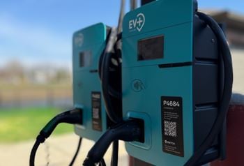 Two electric vehicle charging stations are shown up close.