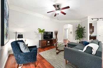 A living room with furniture and a ceiling fan