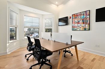 A conference room with a wooden table and chairs