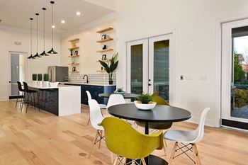 A kitchen and dining area with a table and chairs