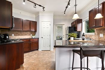 A kitchen with brown cabinets and a counter top