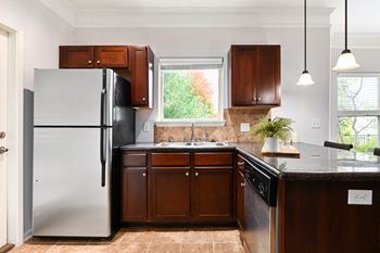 A kitchen with a refrigerator and a sink