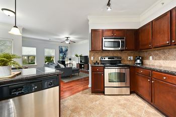 A kitchen with stainless steel appliances and wooden cabinets