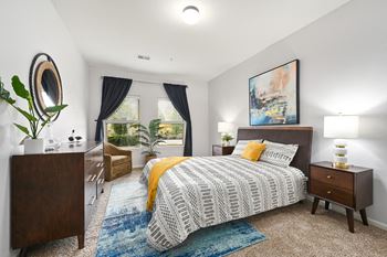 A bedroom with a bed and a window
