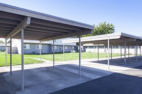 Kennewick apartment for rent - a parking lot with a building in the background