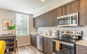 Vancouver apartment for rent - 134th street lofts kitchen with wooden cabinets. stainless steel  stove, microwave and dishwasher