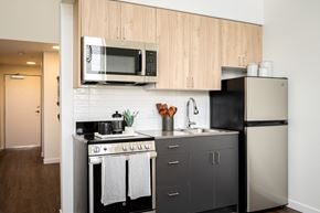 Eugene apartment for rent - a small kitchen with stainless steel appliances and a microwave