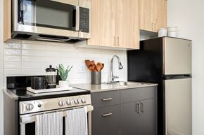 Eugene apartment for rent - a kitchen with stainless steel appliances and wooden cabinets