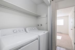 Kennewick apartment for rent - a washer and dryer in a laundry room with a door to a bathroom
